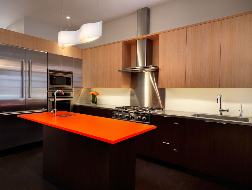 Contemporary kitchen in DC Metro with stainless steel appliances and orange benchtop.