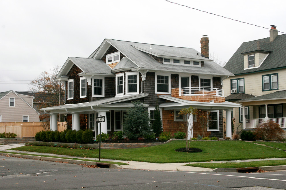 Photo of a large transitional two-storey brown house exterior in New York with wood siding.