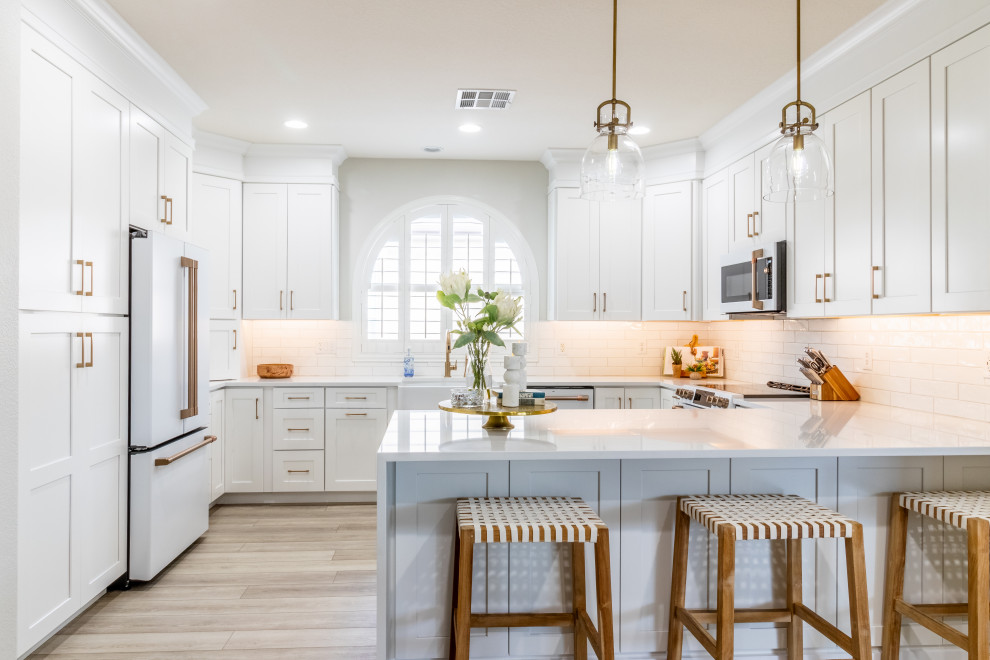 Transitional kitchen photo in Phoenix with shaker cabinets, white cabinets, quartz countertops, white backsplash, white appliances and white countertops