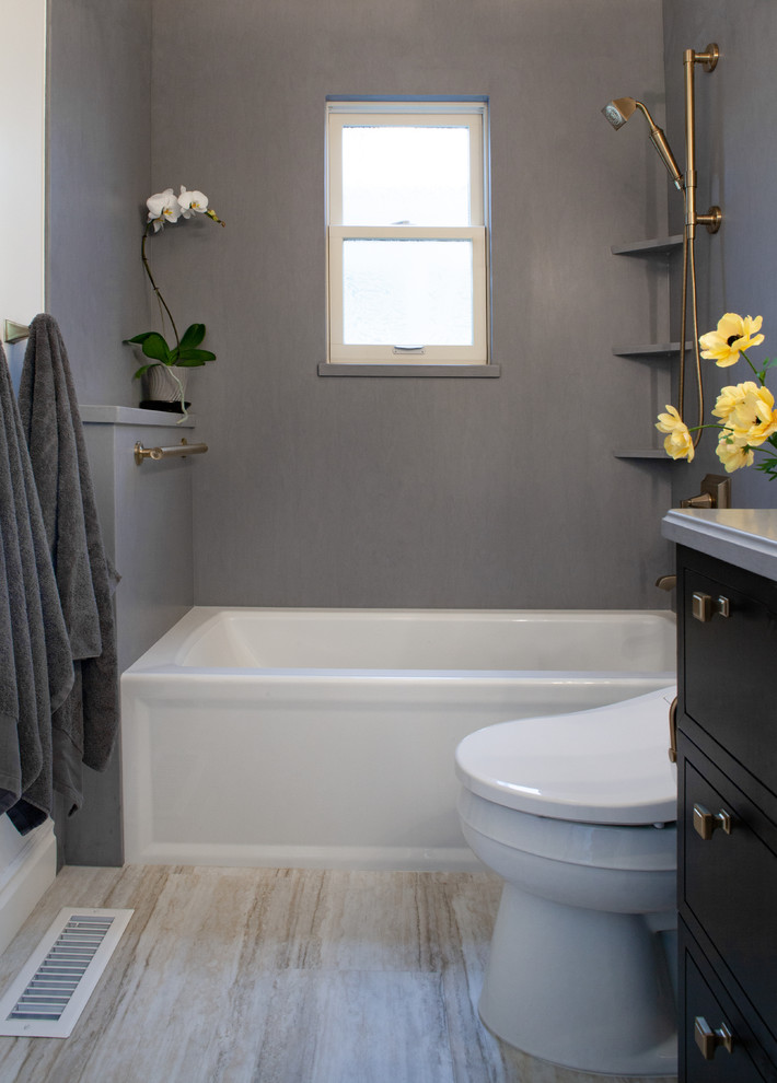 Inspiration for a small traditional master bathroom in San Francisco with furniture-like cabinets, black cabinets, an alcove tub, a shower/bathtub combo, white walls, vinyl floors, an undermount sink, solid surface benchtops, beige floor, a shower curtain and grey benchtops.