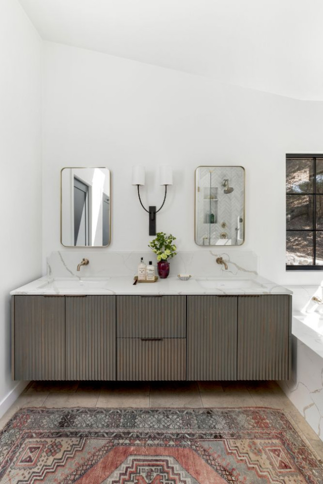 This is an example of a mid-sized country master wet room bathroom in Los Angeles with shaker cabinets, blue cabinets, a drop-in tub, white walls, ceramic floors, an undermount sink, marble benchtops, white floor, a hinged shower door, white benchtops, a double vanity and a built-in vanity.