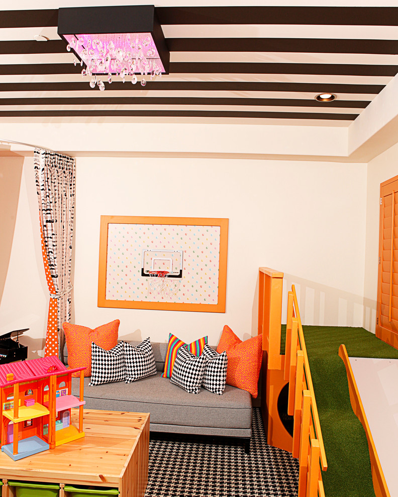 Contemporary gender-neutral kids' playroom in Phoenix with beige walls and carpet.