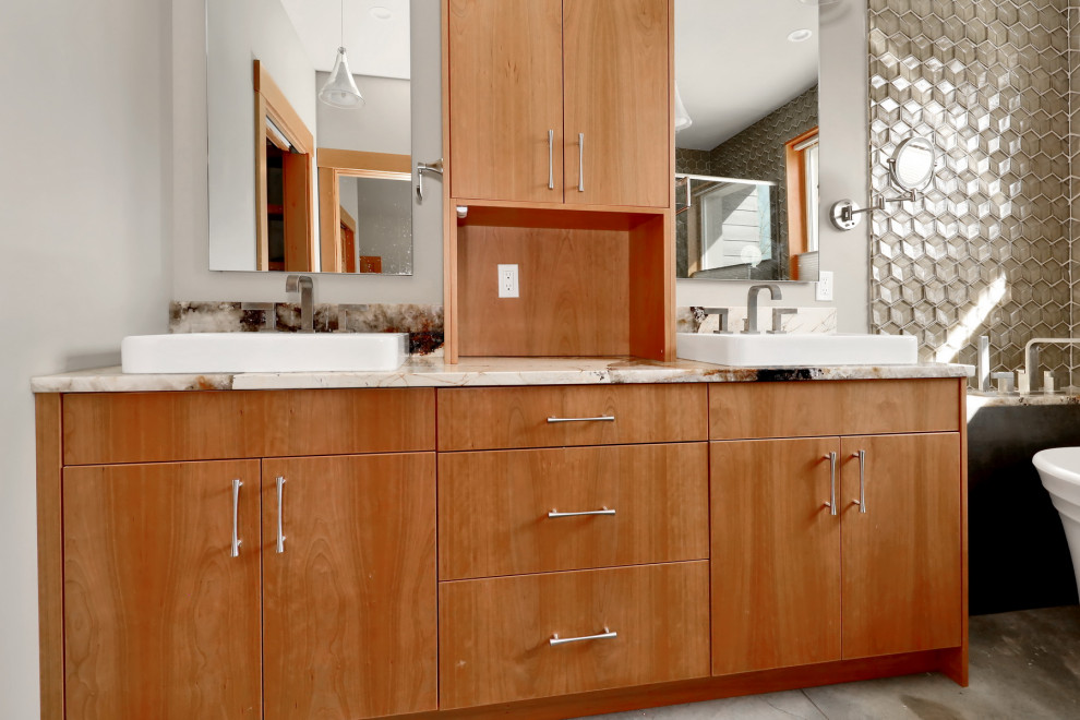 Mid-sized country master bathroom in Seattle with flat-panel cabinets, medium wood cabinets, a freestanding tub, a corner shower, beige tile, glass tile, white walls, concrete floors, a vessel sink, engineered quartz benchtops, grey floor, a hinged shower door, multi-coloured benchtops, a double vanity and a built-in vanity.