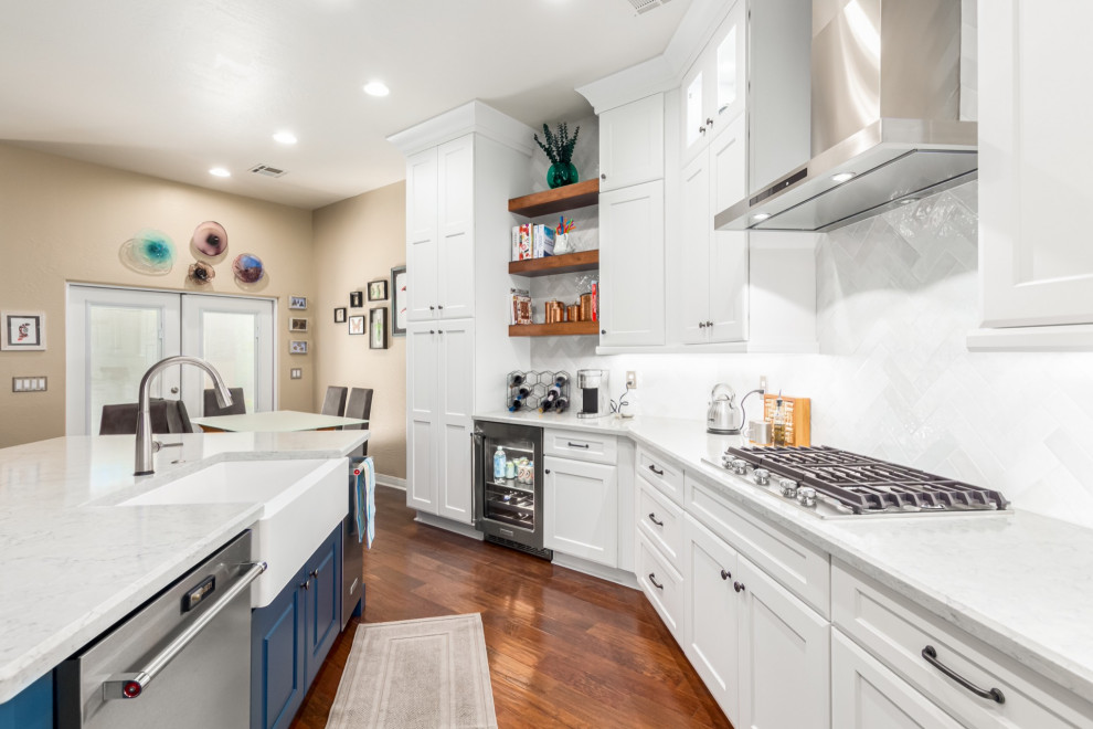 Example of a transitional kitchen design in Phoenix with a farmhouse sink, shaker cabinets, white cabinets, white backsplash, subway tile backsplash and white countertops