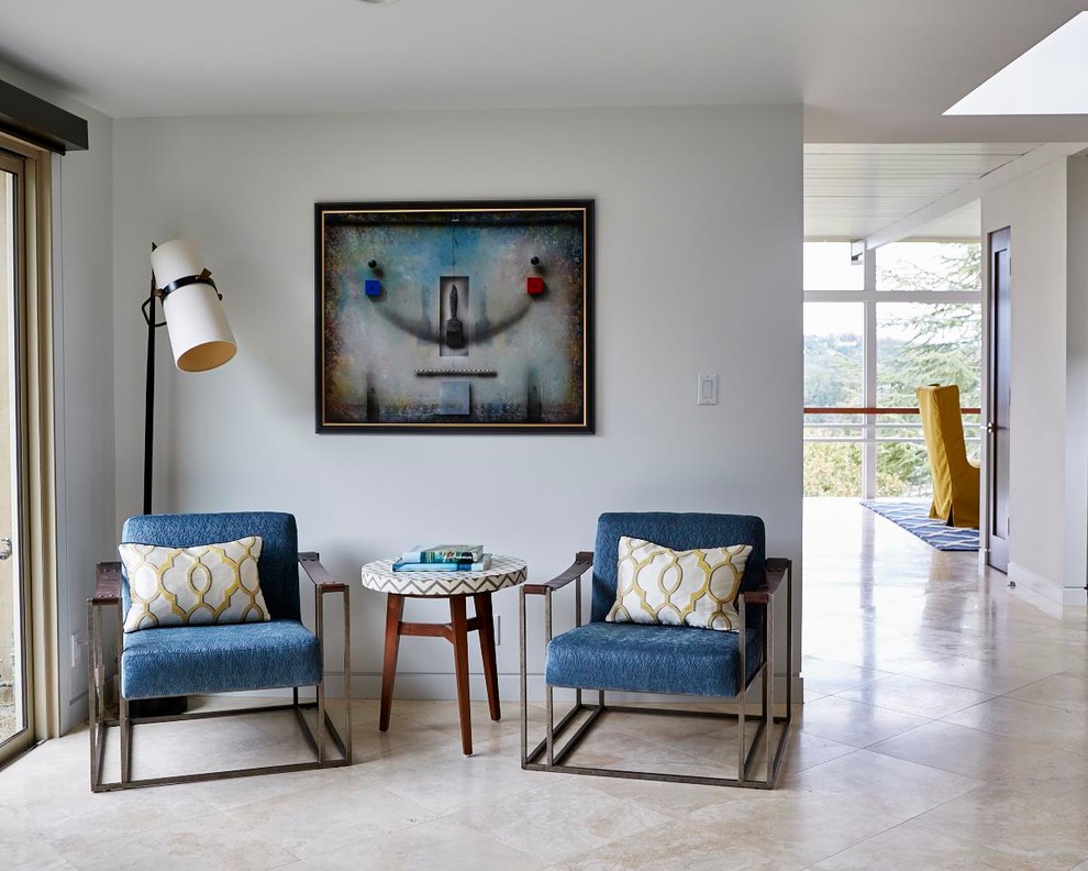 Photo of a mid-sized midcentury open concept family room in San Francisco with white walls, travertine floors and a wall-mounted tv.