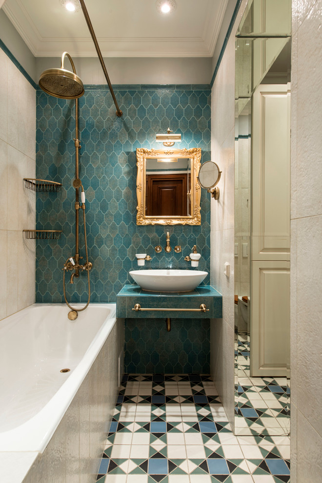 This is an example of a traditional master bathroom in Moscow with flat-panel cabinets, blue cabinets, a shower/bathtub combo, blue tile, blue walls and a vessel sink.