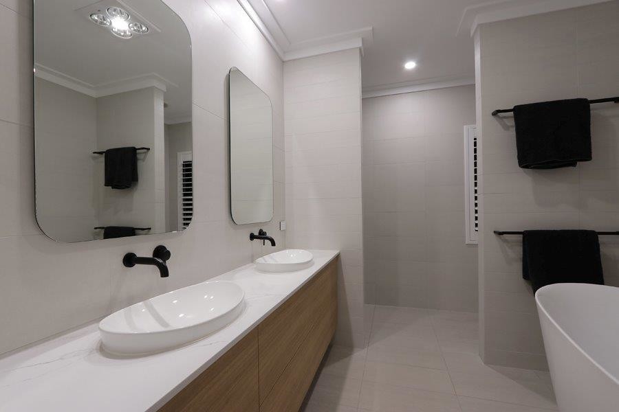 Design ideas for a mid-sized master bathroom in Perth with recessed-panel cabinets, white cabinets, a freestanding tub, an open shower, beige tile, ceramic tile, marble benchtops, an open shower, white benchtops, beige walls, ceramic floors, a drop-in sink and beige floor.