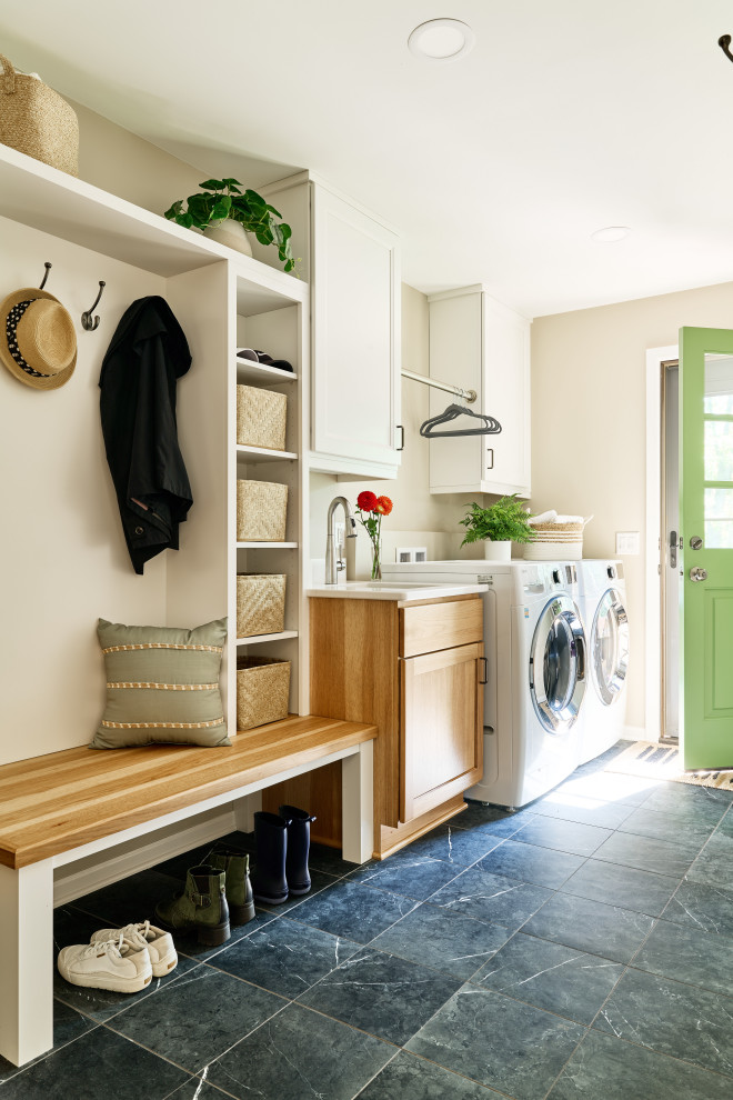 Example of a mid-sized transitional single-wall porcelain tile utility room design in Minneapolis with an undermount sink, recessed-panel cabinets, light wood cabinets, quartz countertops, beige walls, a side-by-side washer/dryer and white countertops