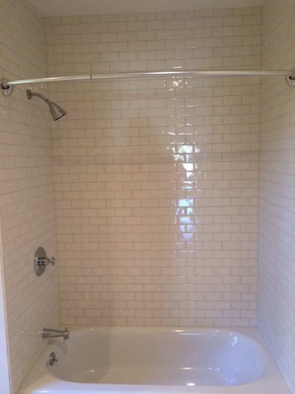 Design ideas for a mid-sized traditional 3/4 bathroom in Boston with an alcove tub, a shower/bathtub combo, white tile, porcelain tile and white walls.