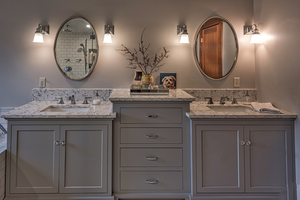 Inspiration for a large arts and crafts master bathroom in Portland with shaker cabinets, grey cabinets, white tile, subway tile, grey walls, an undermount sink, grey benchtops, a drop-in tub, a double shower, a one-piece toilet, marble floors, marble benchtops and a hinged shower door.