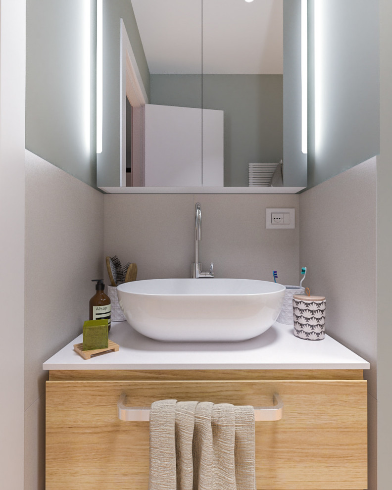 Photo of a small contemporary 3/4 bathroom in Milan with flat-panel cabinets, light wood cabinets, an alcove shower, a two-piece toilet, multi-coloured tile, porcelain tile, green walls, light hardwood floors, a vessel sink, laminate benchtops, a sliding shower screen, white benchtops, a single vanity, a floating vanity and recessed.