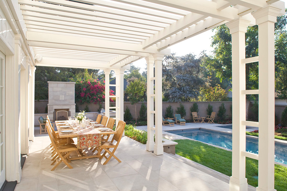 Inspiration for a traditional patio in Los Angeles with a fire feature and a pergola.