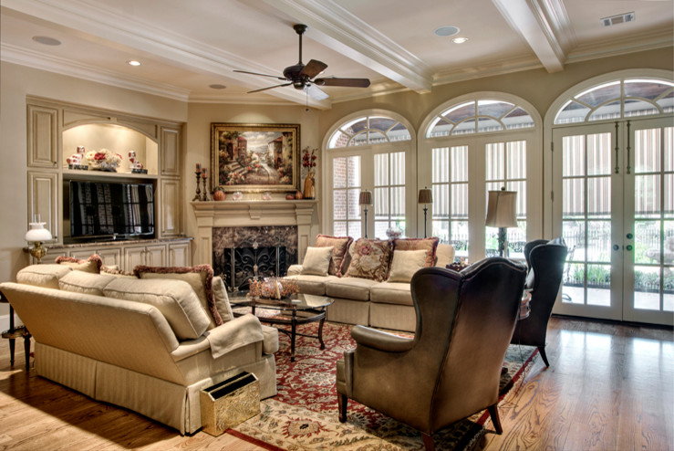 Design ideas for a large traditional open concept family room in Houston with beige walls, medium hardwood floors, a corner fireplace, a stone fireplace surround and a freestanding tv.