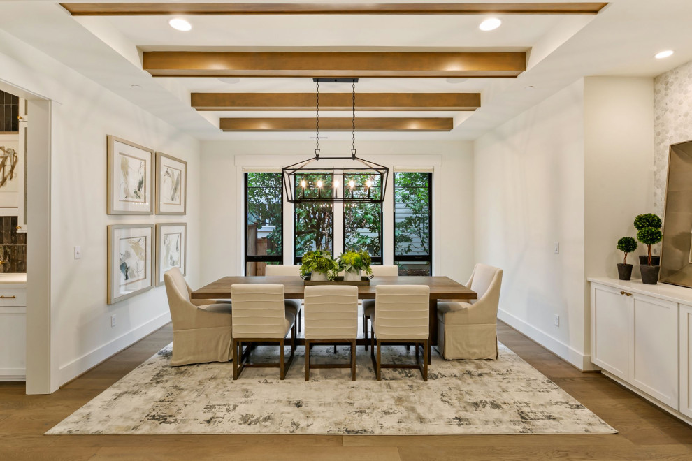 Inspiration for a large country kitchen/dining combo in Seattle with white walls, light hardwood floors, brown floor and timber.
