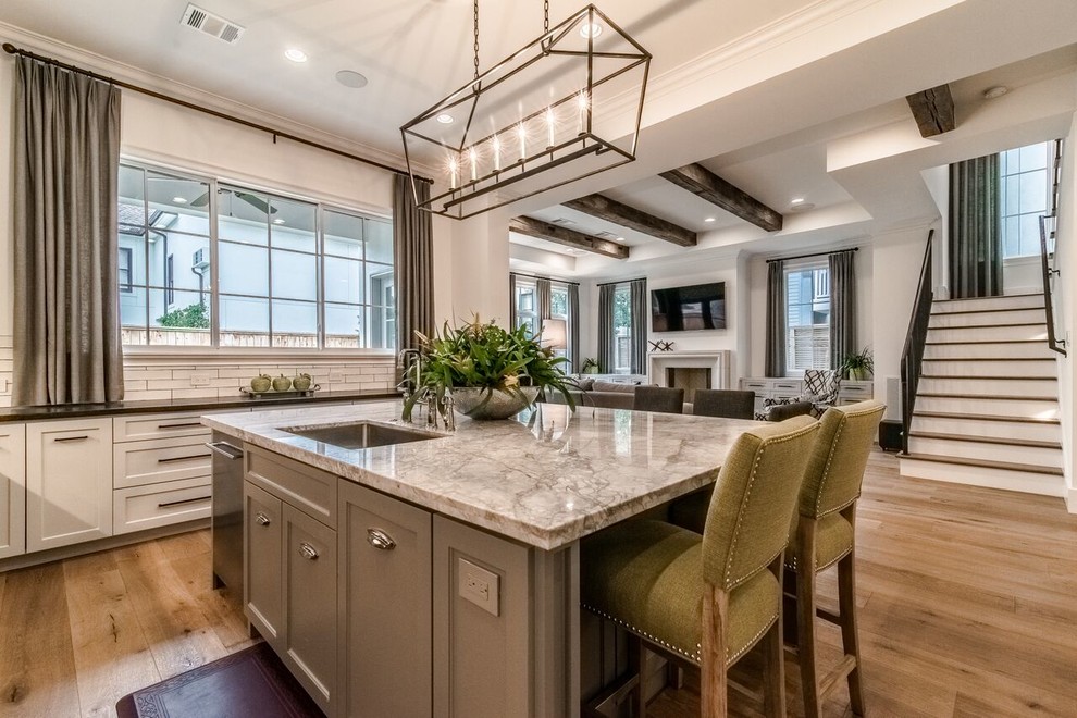Inspiration for a large transitional u-shaped open plan kitchen in Houston with shaker cabinets, grey cabinets, quartzite benchtops, white splashback and with island.
