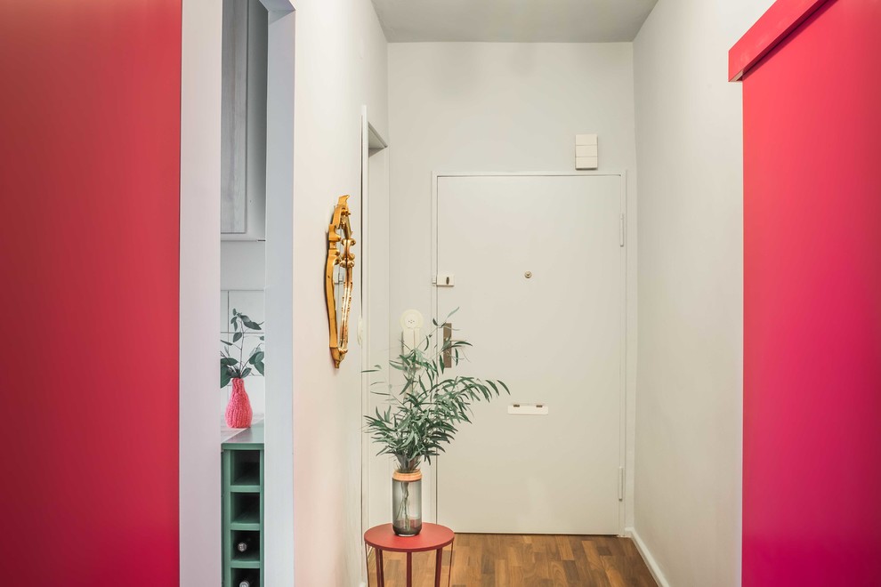Design ideas for a mid-sized scandinavian hallway in Berlin with white walls, dark hardwood floors and brown floor.