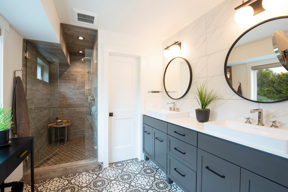 Country bathroom in San Francisco with grey cabinets, white tile, ceramic tile, white walls, a vessel sink, multi-coloured floor, a double vanity and a built-in vanity.