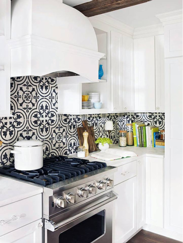 Mid-sized trendy medium tone wood floor and brown floor kitchen photo with shaker cabinets, white cabinets, quartz countertops, multicolored backsplash, cement tile backsplash, stainless steel appliances and white countertops