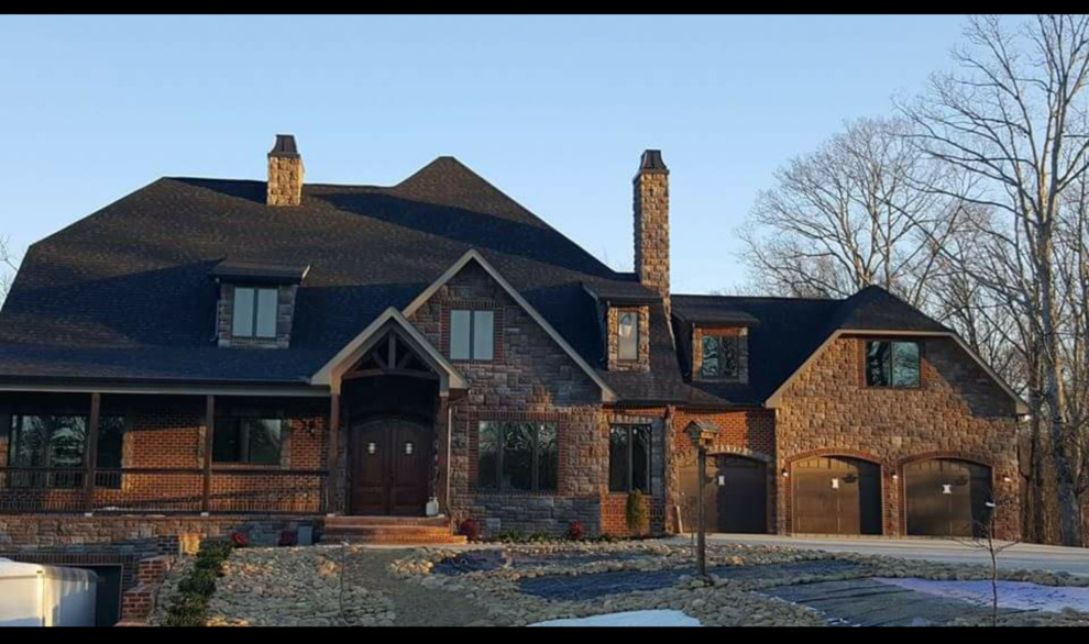 Mountain style brown three-story brick exterior home photo