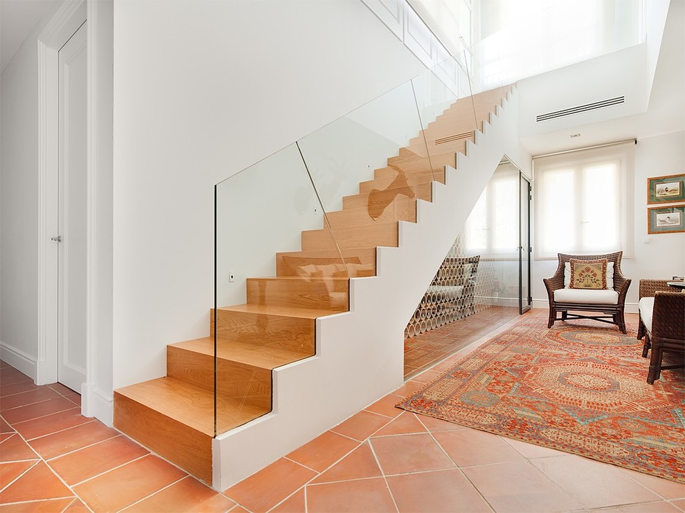 Mid-sized transitional wood straight staircase in Madrid with wood risers.