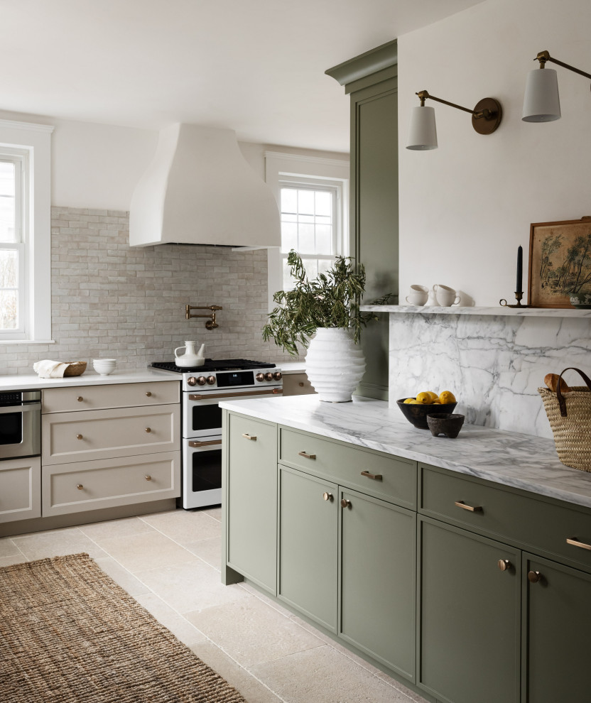 Mid-sized transitional l-shaped separate kitchen in Boston with shaker cabinets, green cabinets, marble benchtops, marble splashback, white appliances, limestone floors, beige floor, beige splashback, no island and white benchtop.