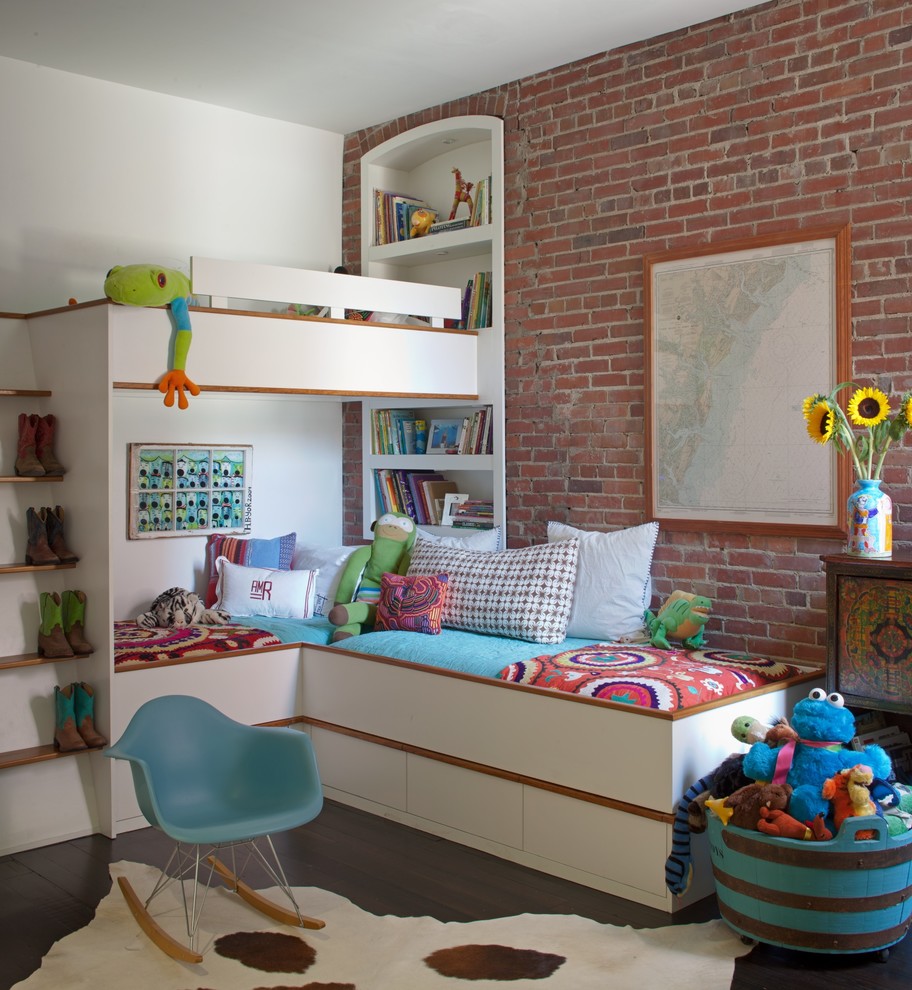 This is an example of an urban gender neutral children’s room in Atlanta with dark hardwood flooring and red walls.