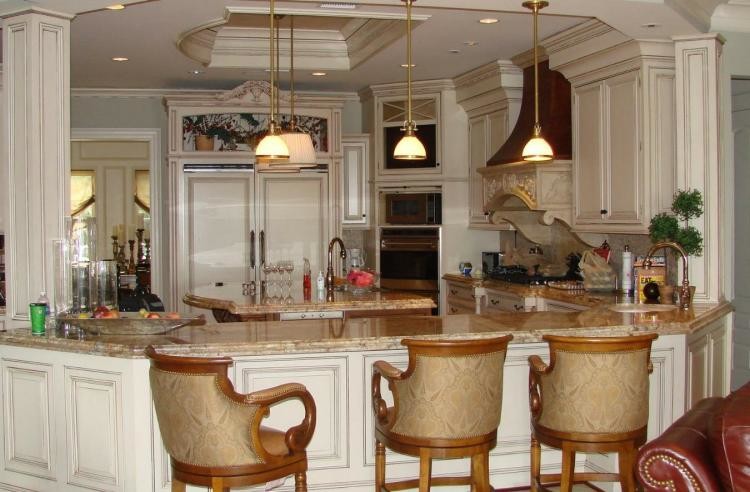 Open concept kitchen - medium tone wood floor open concept kitchen idea with raised-panel cabinets, white cabinets, granite countertops, beige backsplash, stainless steel appliances and an island