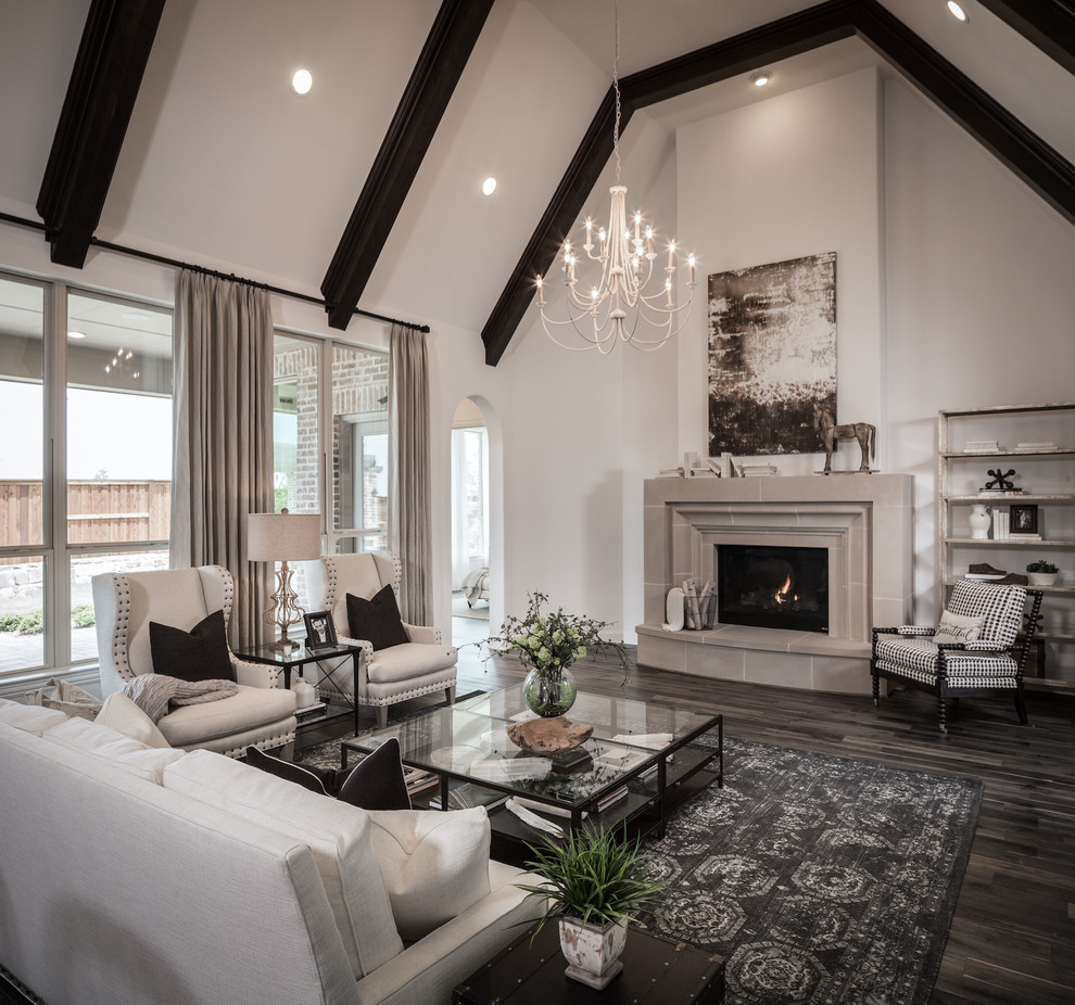 Photo of a large traditional open concept living room in Dallas with white walls, dark hardwood floors, a standard fireplace and a tile fireplace surround.