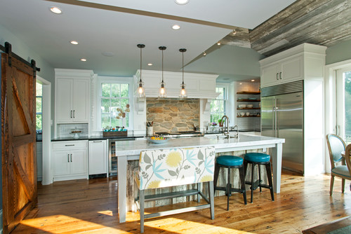 Farmhouse kitchen cabinet layout with white shaker cabinets, rustic wood accents, and a large island