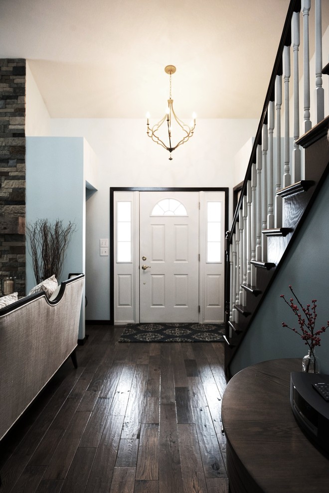 Inspiration for a mid-sized transitional dark wood floor foyer remodel with blue walls and a white front door