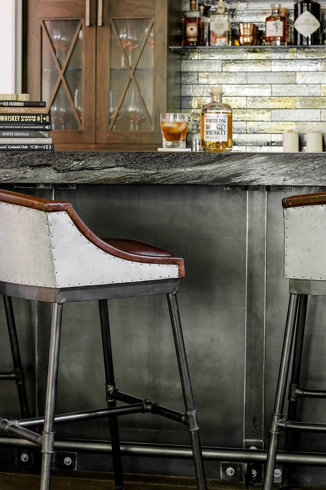 This is an example of a small country single-wall wet bar in New York with an undermount sink, distressed cabinets, concrete benchtops, multi-coloured splashback, metal splashback and medium hardwood floors.