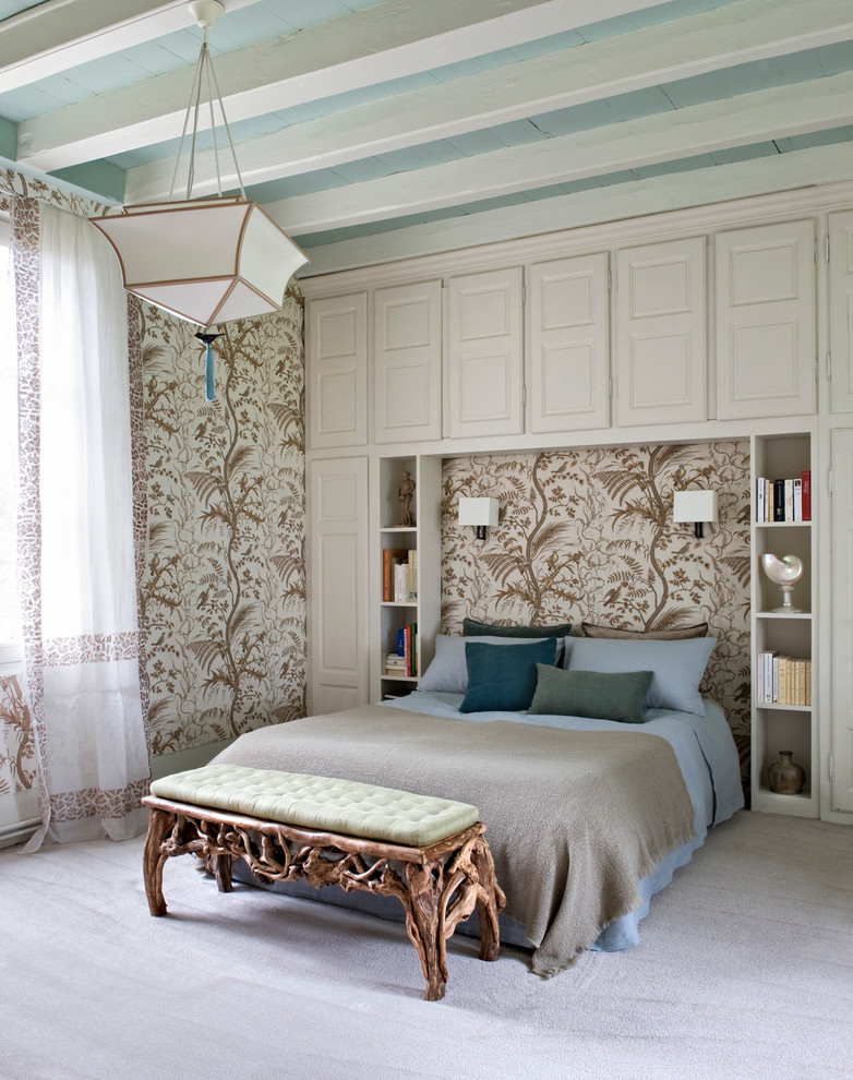 Inspiration for a large tropical master bedroom in Paris with carpet.