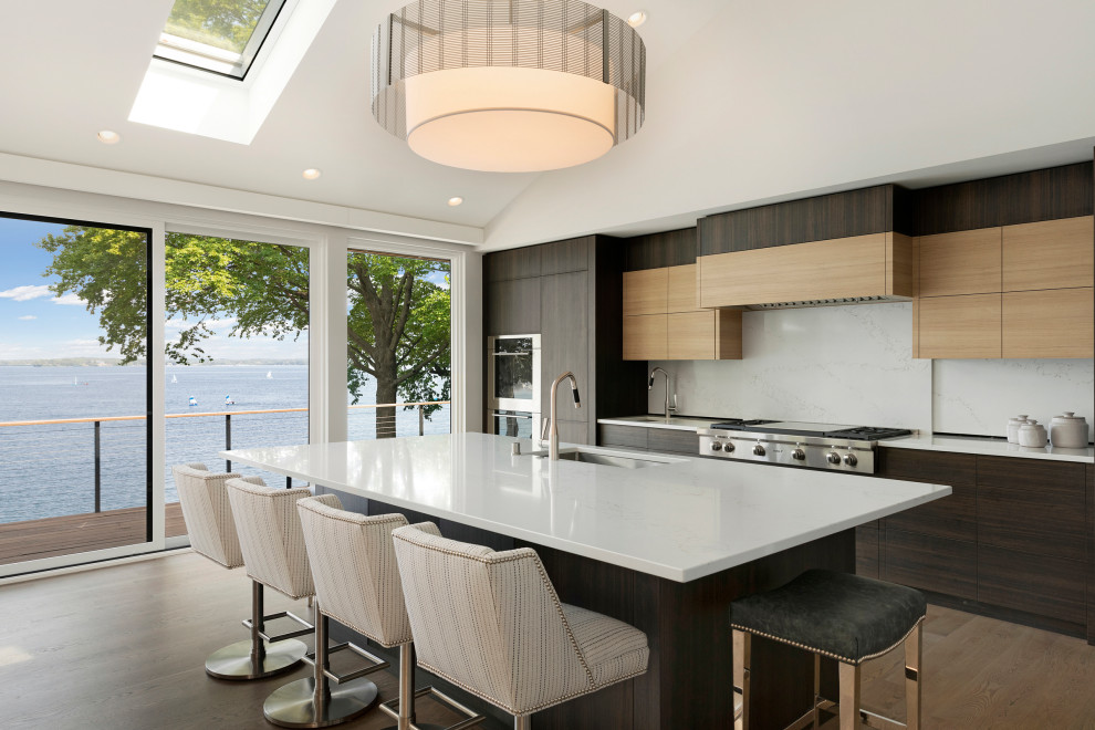 This is an example of a contemporary single-wall kitchen in Minneapolis with flat-panel cabinets, an island and white worktops.