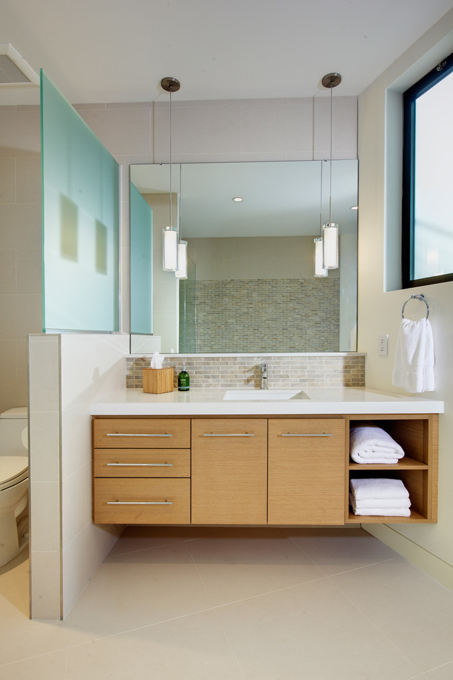 Design ideas for a contemporary bathroom in Sacramento with flat-panel cabinets, medium wood cabinets, beige walls and an undermount sink.