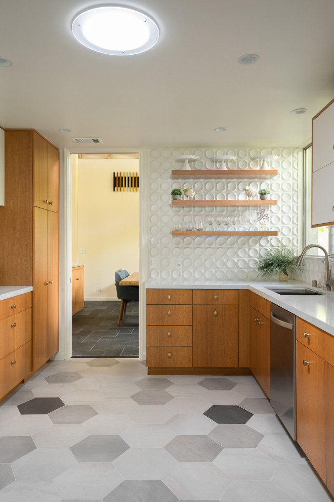 Inspiration for a mid-sized midcentury u-shaped eat-in kitchen in Los Angeles with an undermount sink, flat-panel cabinets, medium wood cabinets, quartz benchtops, white splashback, ceramic splashback, stainless steel appliances, porcelain floors, grey floor and white benchtop.