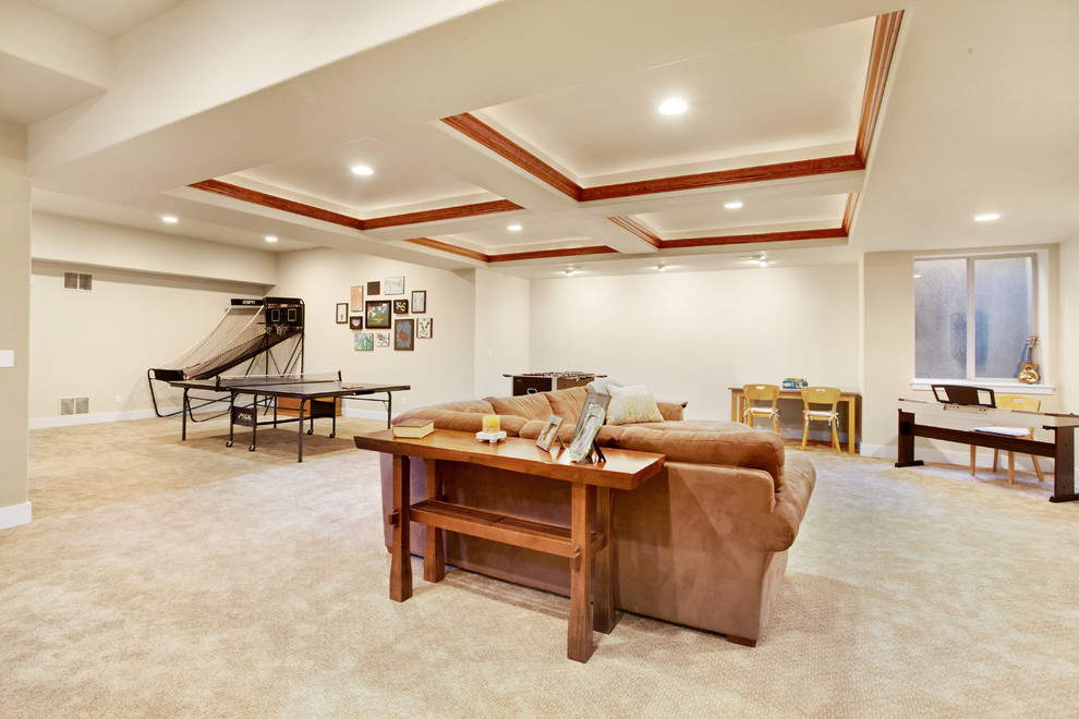Large arts and crafts fully buried basement in Denver with beige walls, carpet and beige floor.