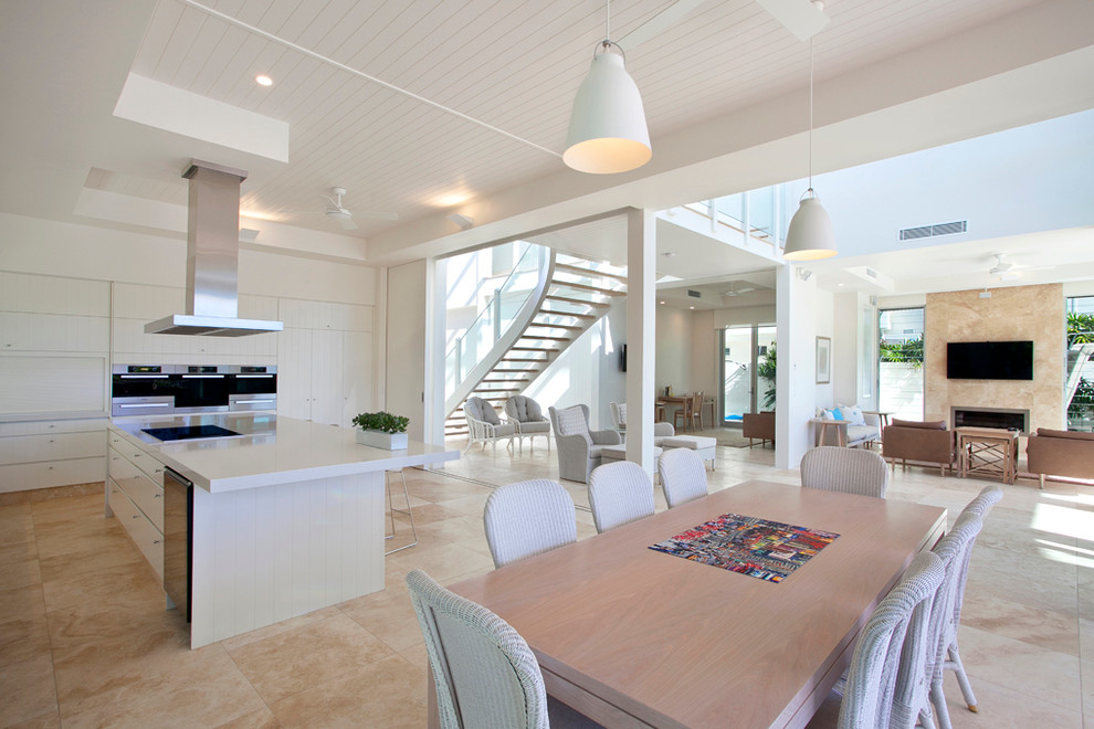 Photo of a large contemporary open plan dining in Sunshine Coast with white walls and beige floor.