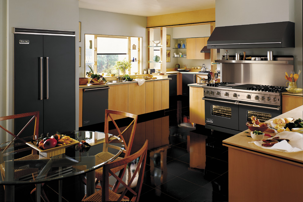 Photo of an asian eat-in kitchen in San Francisco with flat-panel cabinets and light wood cabinets.