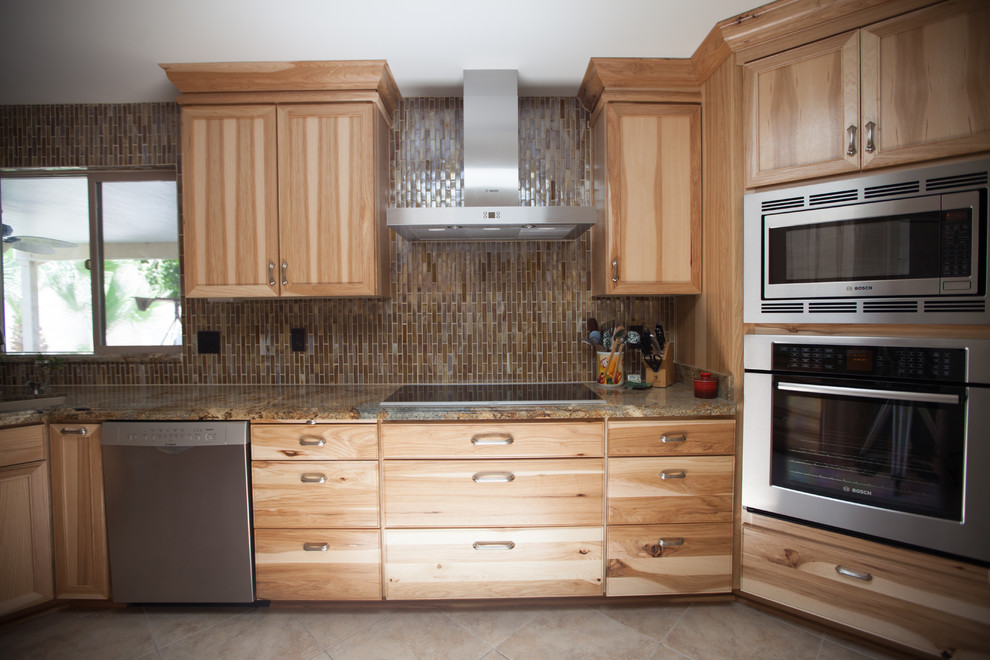 Large transitional galley ceramic tile enclosed kitchen photo in Phoenix with an undermount sink, recessed-panel cabinets, light wood cabinets, granite countertops, brown backsplash, glass tile backsplash and stainless steel appliances