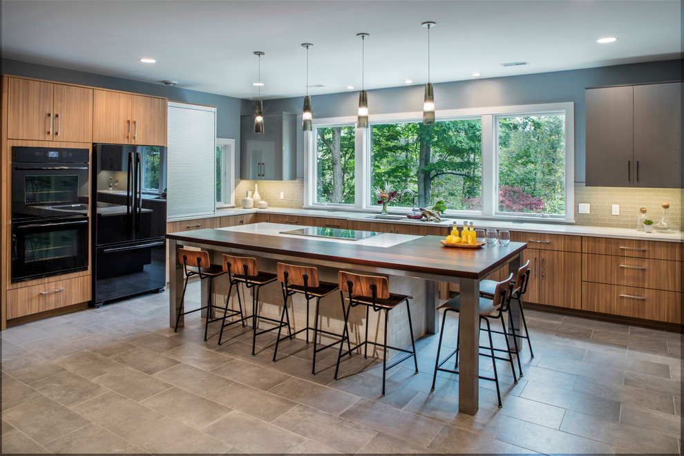 Inspiration for a contemporary l-shaped separate kitchen in Grand Rapids with flat-panel cabinets, medium wood cabinets, black appliances, with island, beige splashback and subway tile splashback.