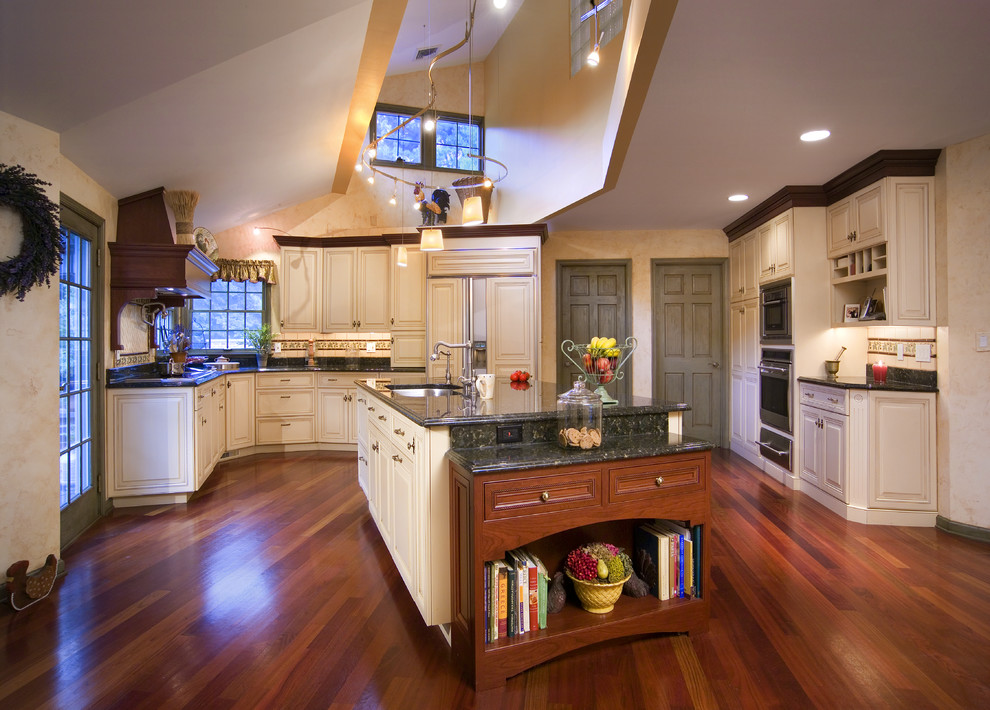 Example of a classic kitchen design in Philadelphia with raised-panel cabinets and beige cabinets