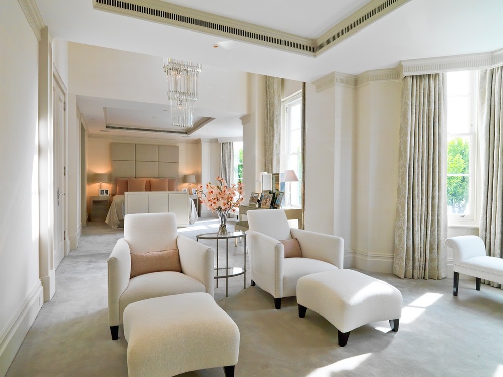 Design ideas for a large transitional master bedroom in London with beige walls and carpet.
