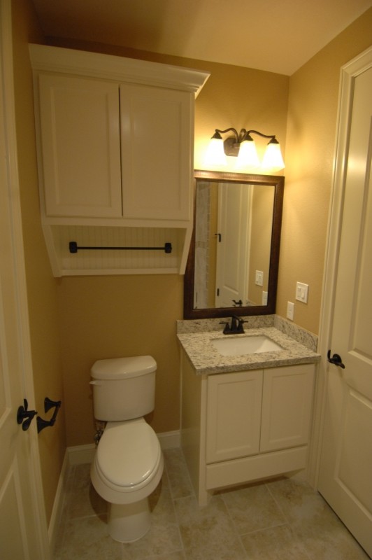 Inspiration for a mid-sized traditional master bathroom in Austin with raised-panel cabinets, white cabinets, an alcove tub, an alcove shower, beige tile, stone tile, beige walls, ceramic floors, an undermount sink and granite benchtops.