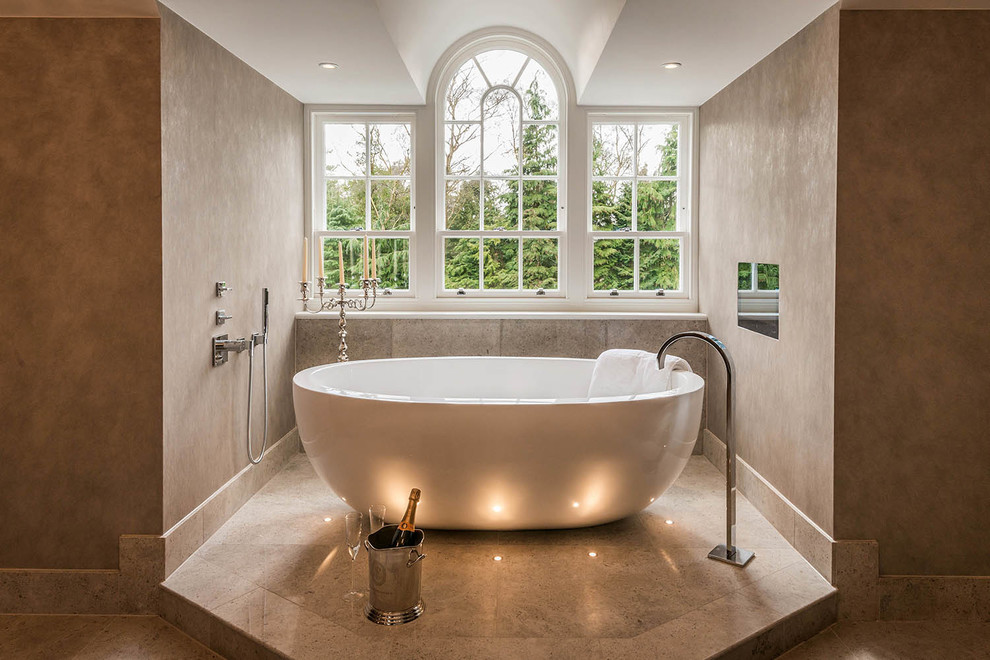 This is an example of a large contemporary bathroom in Surrey with a freestanding tub.