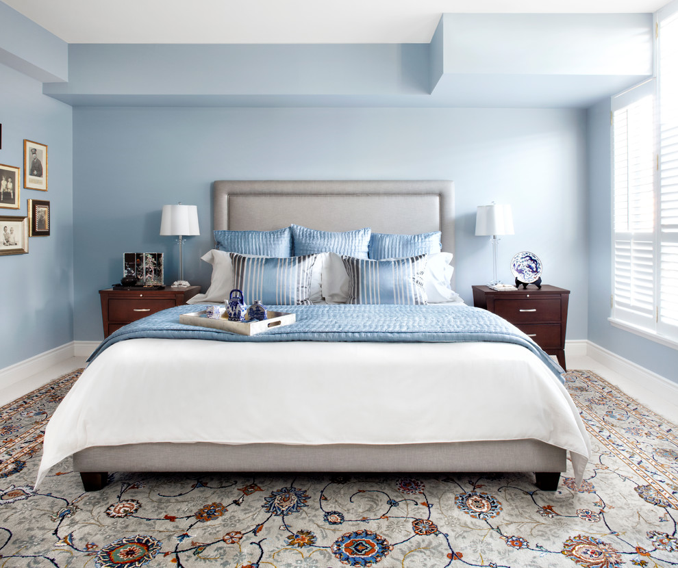 Design ideas for a mid-sized transitional master bedroom in Toronto with blue walls and carpet.