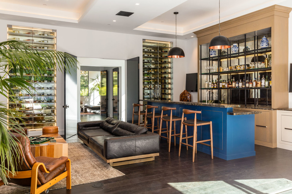 Inspiration for an expansive contemporary u-shaped seated home bar in Los Angeles with open cabinets, mirror splashback, dark hardwood floors, brown floor, beige cabinets and granite benchtops.