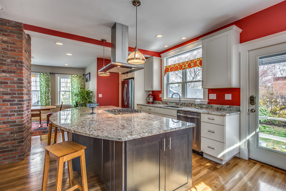 Mid-sized transitional galley light wood floor and beige floor eat-in kitchen photo in Boston with an undermount sink, shaker cabinets, white cabinets, granite countertops, red backsplash, stainless steel appliances and an island