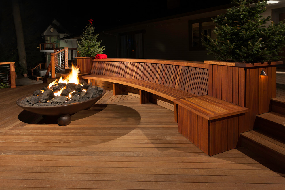 Design ideas for an expansive contemporary backyard deck in New York with a fire feature and no cover.