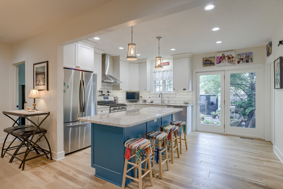 Eat-in kitchen - small transitional l-shaped eat-in kitchen idea with recessed-panel cabinets, turquoise cabinets, quartz countertops and an island