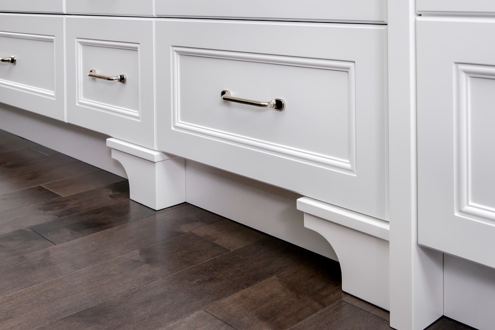 Inspiration for a large transitional single-wall dark wood floor eat-in kitchen remodel in Calgary with an undermount sink, white cabinets, quartz countertops, multicolored backsplash, stone tile backsplash, paneled appliances and an island